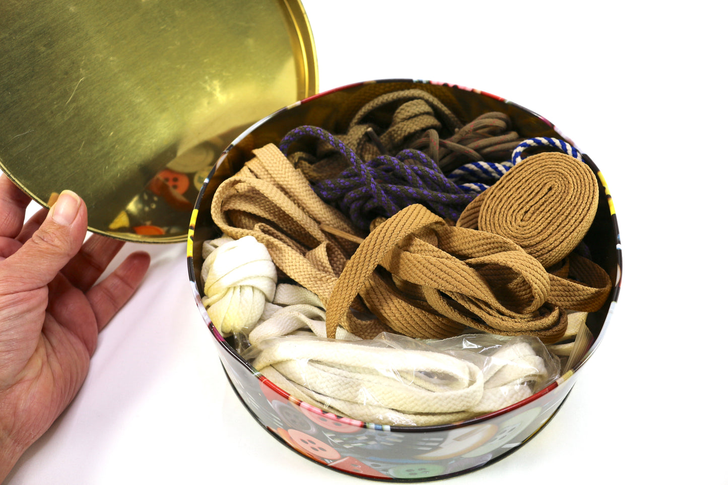 Button Tin filled with a Variety of Shoelaces